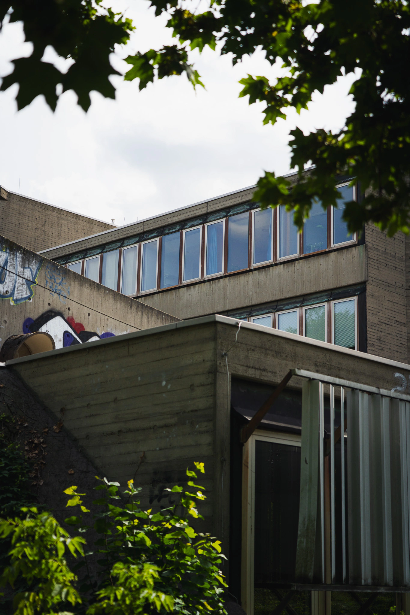 Institute building with band windows and graffiti-covered concrete