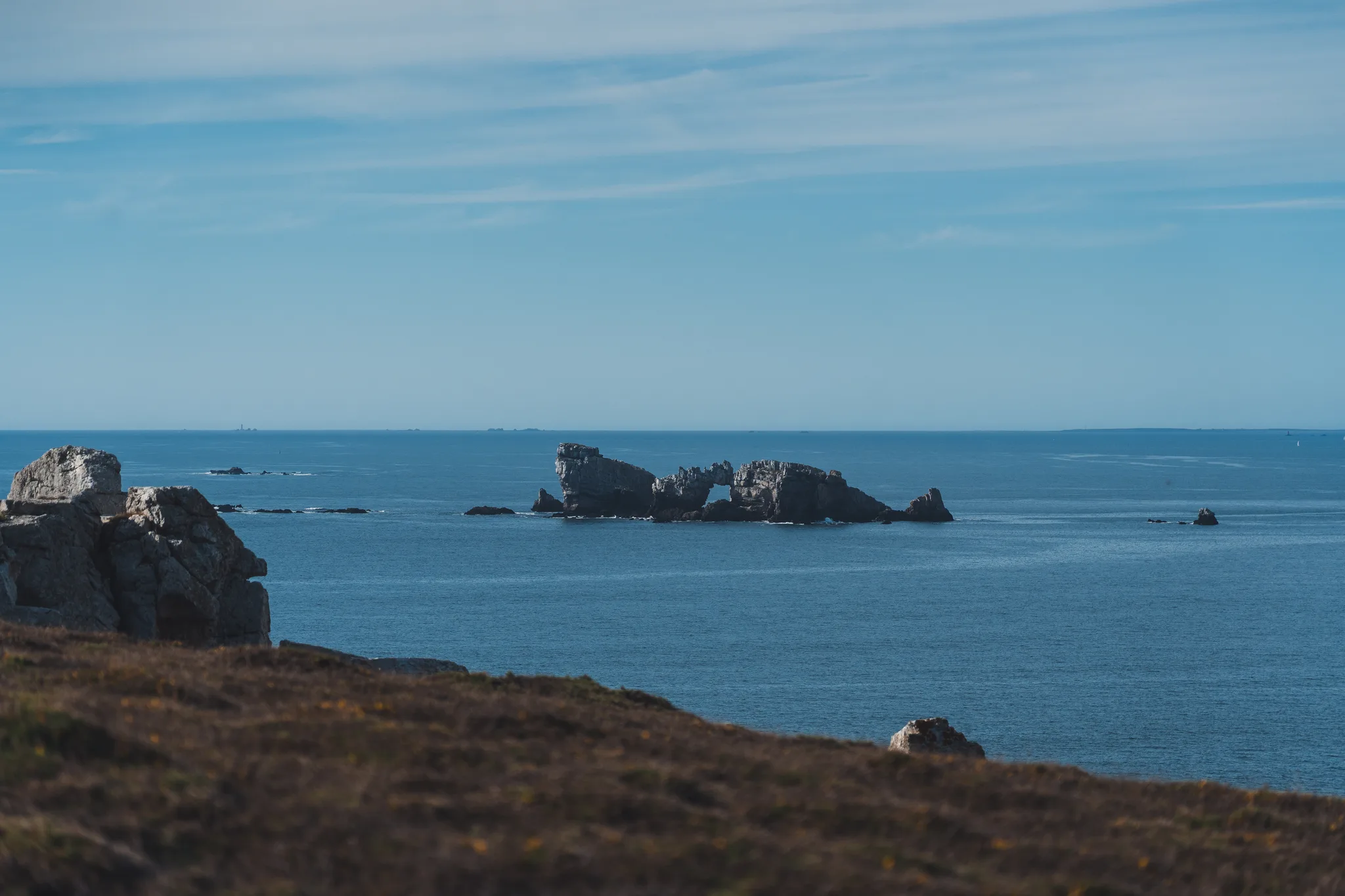 Château de Dinan rock beyond a brown heath-covered cliff top