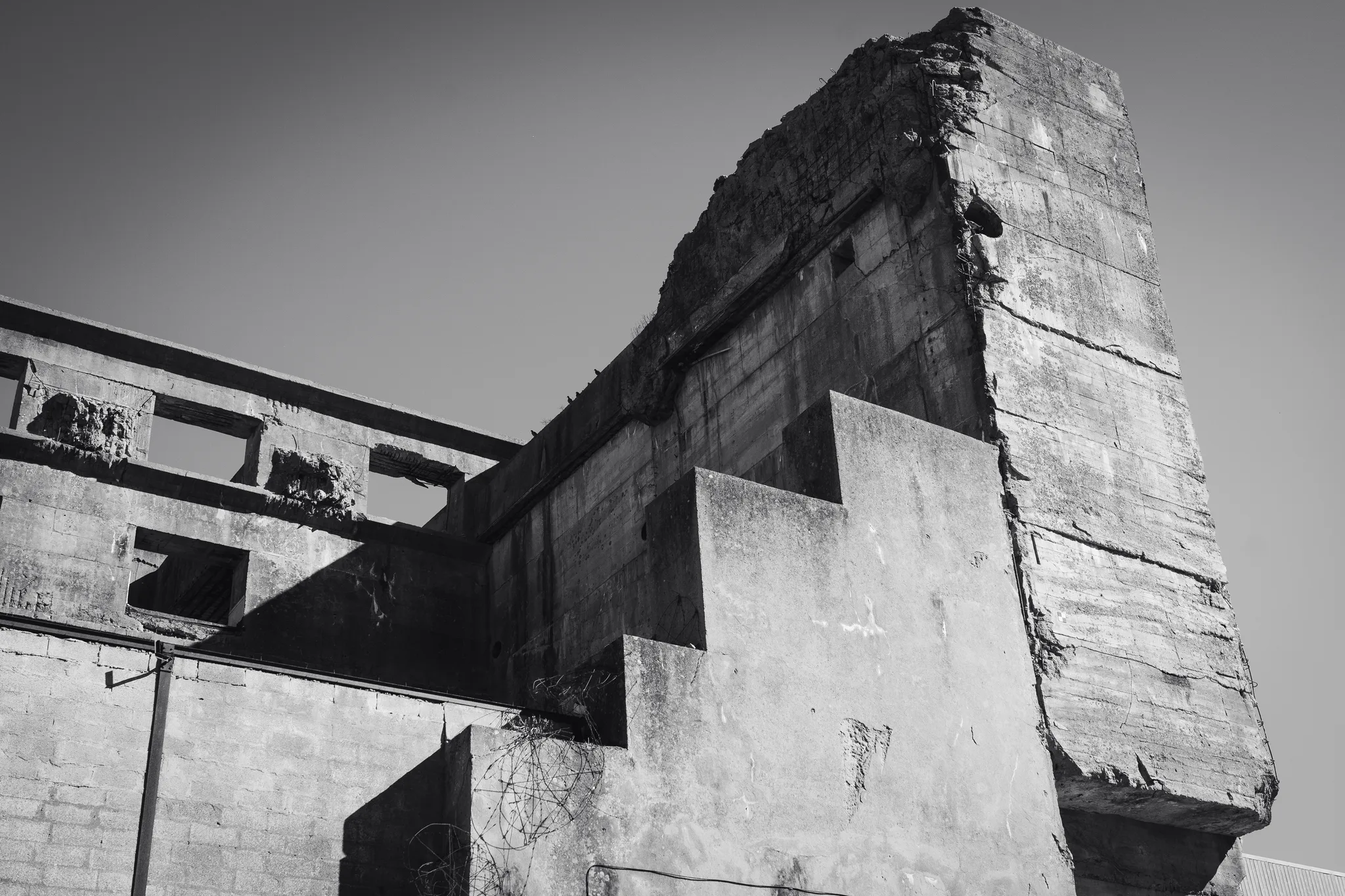 Stepped concrete wall of a submarine bunker at Keroman, black and white