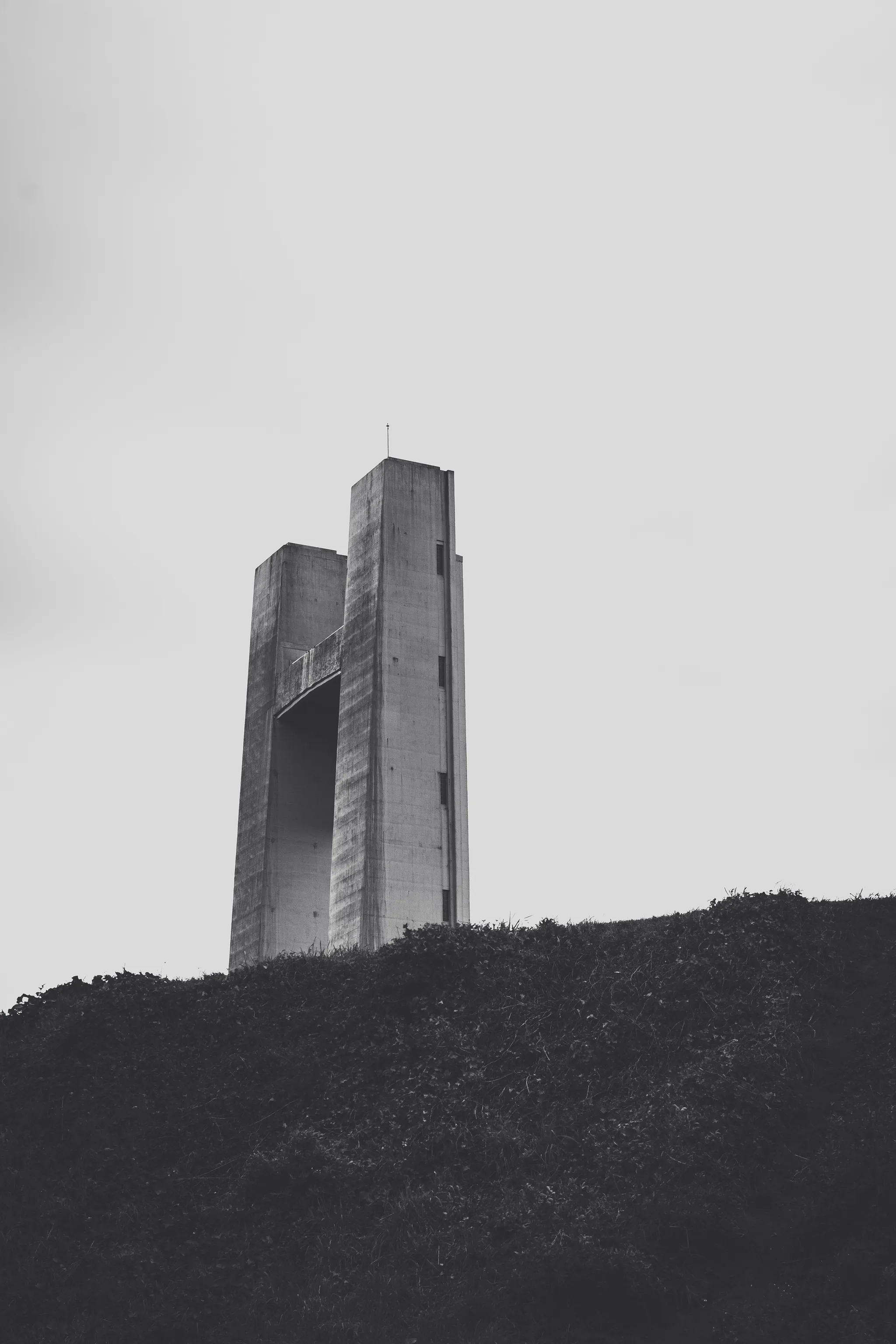 Concrete pylon of the Pont de Recouvrance on a hill, black and white