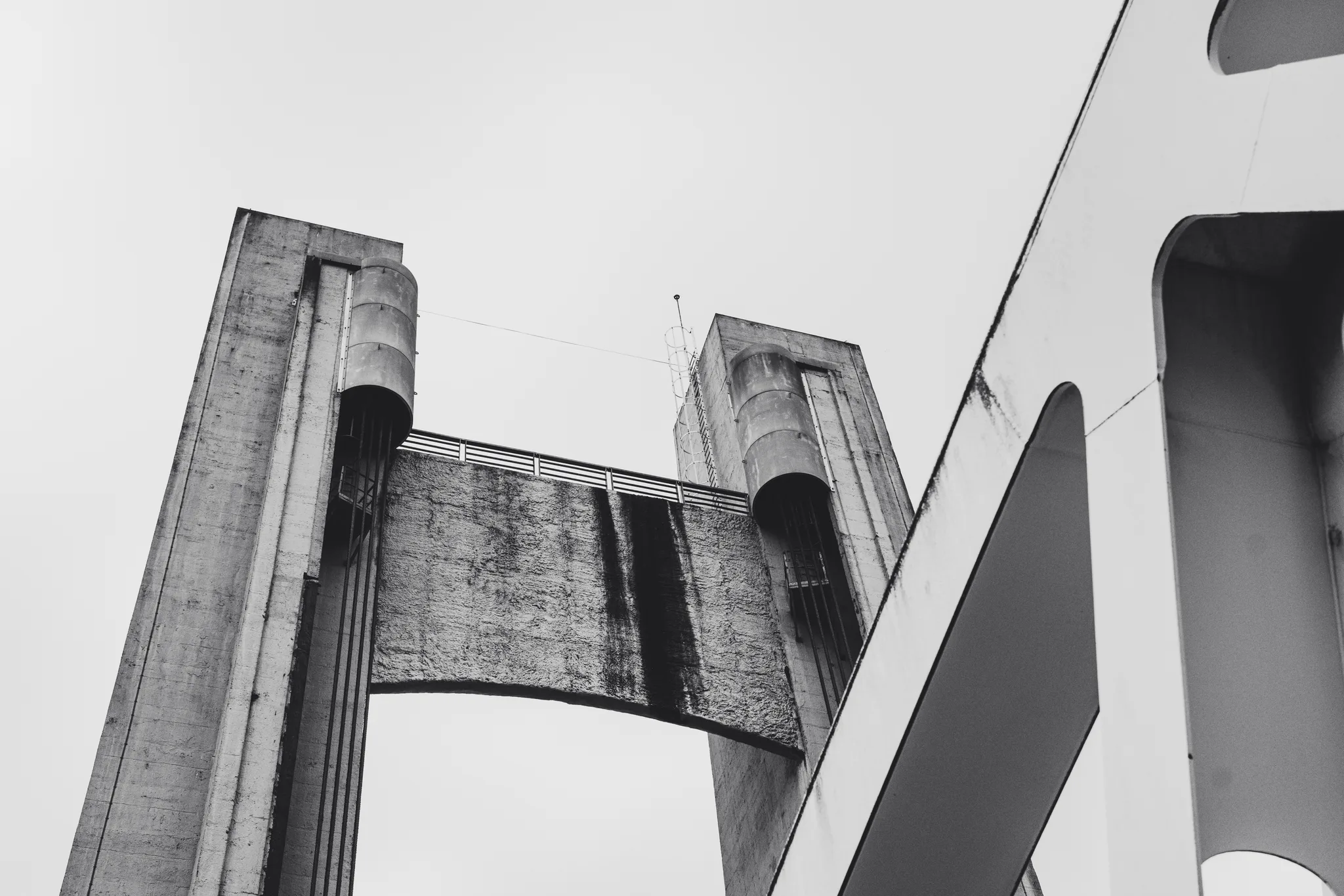 The two concrete towers and lifting deck of the Pont de Recouvrance from below, black and white